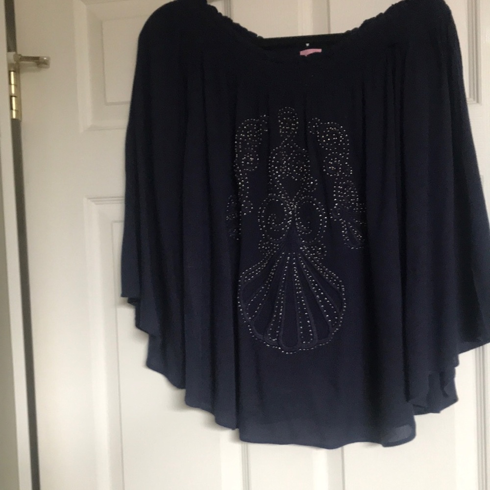 Beautiful navy top with gold design in it drapes off the shoulders